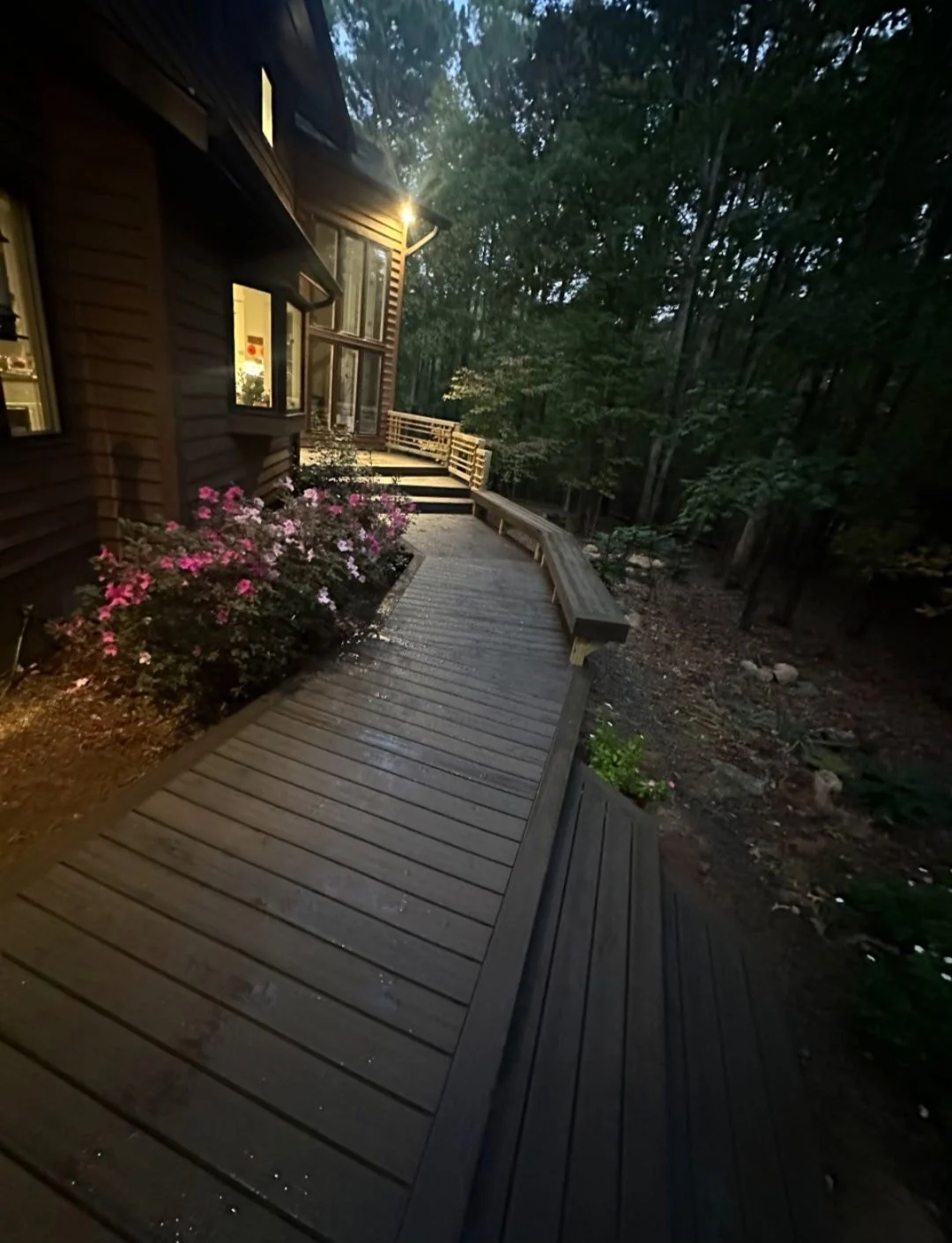 Composite side walkway with built-in bench and planter of pink flowers